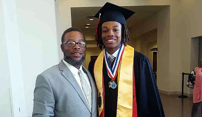 Pelahatchie High School football and baseball coach Cedrick Wilder poses with his son, Cedrick “CJ” Wilder Jr., at his high school graduation in 2019. Photo courtesy Cedrick Wilder