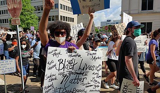 A protester at the June 6, 2020, Black Lives Matter rally in downtown Jackson holds a sign emblazoned with the names of some of the many police-violence victims in America in recent years. Photo by Nick Judin