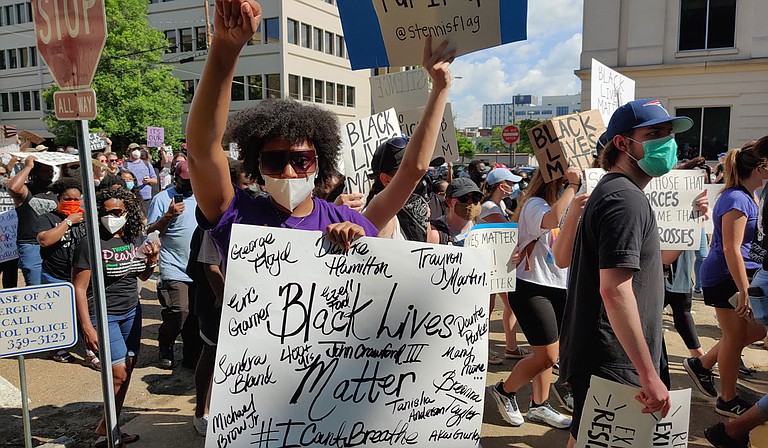 A protester at the June 6, 2020, Black Lives Matter rally in downtown Jackson holds a sign emblazoned with the names of some of the many police-violence victims in America in recent years. Photo by Nick Judin