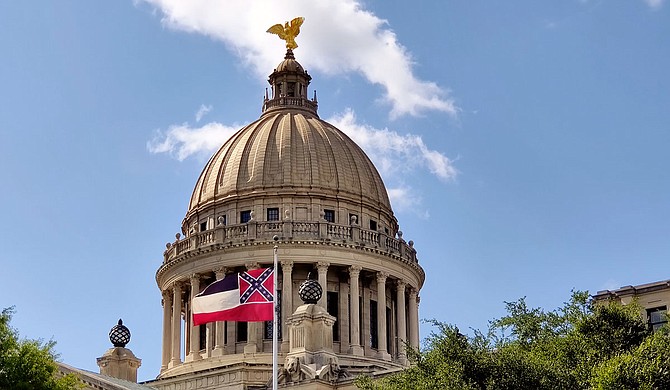Joshua D. Dedmond and M. Endesha Juakali of Cooperation Jackson write that the Mississippi state flag “represents a time when most people of African descent were bound in chattel slavery and could be sold like cattle and bred like dogs.” Photo by Nick Judin