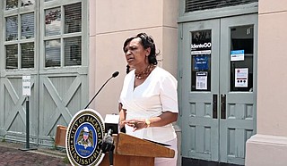 Jackson City Clerk Angela Harris stands in front of the old chamber of commerce building to announce a new TSA PreCheck program. Photo courtesy City of Jackson