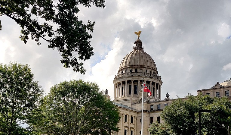 Mississippi will have a new state flag without Confederate symbolism after a legislative supermajority voted to retire the 1894 design. The old state flag flew for the last time above the Capitol on Sunday, now consigned to history with the Confederacy it once honored. Photo by Nick Judin