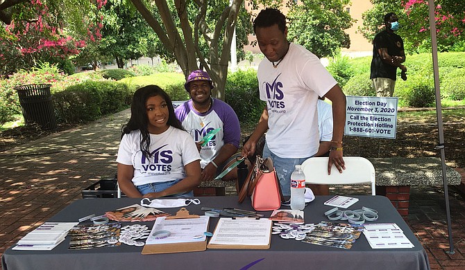 Members of Mississippi Votes set up a stand at a voter-registration event June 28 at Jackson City Hall. Photo by Kayode Crown