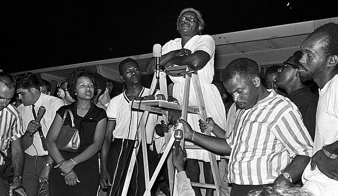 Activist Flonzie Brown Wright, left, and John Lewis, right (holding ladder), listen as Annie Devine, known as the “Mother of the Movement,” stands on the ladder addressing a huge crowd of marchers from across the country in Canton, Miss., in support of James Meredith’s 1966 March Against Fear. Photo courtesy Alabama Department of Archives and History
