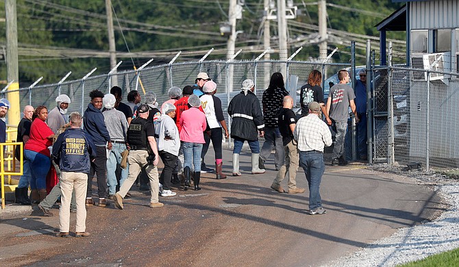 Four executives from two Mississippi poultry processing plants have been indicted on federal charges tied to one of the largest workplace immigration raids in the U.S. in the past decade. Photo by Rogelio V. Solis via AP