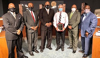 Outgoing Hinds County Emergency Management Director Ricky Moore is surrounded by members of the Board of Supervisors after they presented him with a plaque in recognition of his service. His tenure ends Aug. 31. Moore urges the continued use of facial coverings to fight the novel coronavirus. Photo courtesy Hinds County