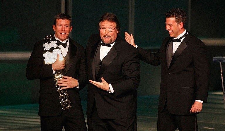 In this March 27, 2010, file photo, WWE Superstar Ted DiBiase Jr. (left), with brother Brett DiBiase (right), induct their father "Million Dollar Man" Ted DiBiase (center) into the 2010 WWE Hall of Fame at the Ceremony in Phoenix, Ariz. Photo courtesy Rick Scuteri/WWE via AP