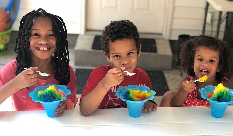 Co-owner Jeremy Harper’s children enjoy shaved ice prepared by CrunchTime Concessions. Photo courtesy CrunchTime Concessions
