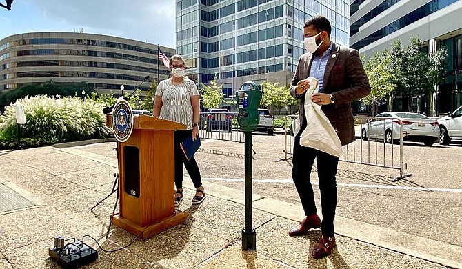 Mayor Chokwe A. Lumumba unveils one of the parking meters on North Lamar Street on Tuesday as Director of Planning and Development Jordan Hillman looks on. Photo courtesy City of Jackson