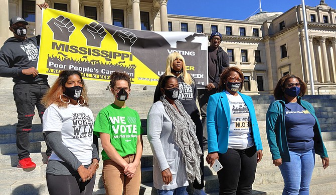 Representatives from several grassroots organizations, including the Mississippi Poor People’s Campaign, held an event on the steps of the State Capitol today, castigating state officials for sudden polling place changes. From left, Rukia Lumumba, Miranda, a Hinds County resident, Sharon Brown, Danyelle Holmes, Nsombi Lambright. Photo by Nick Judin