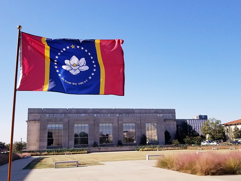 A new Mississippi flag without Confederate images was flying in parts of the state on Wednesday, one day after a majority voters approved the design that has a magnolia encircled by stars and the phrase “In God We Trust.” Photo courtesy MDAH