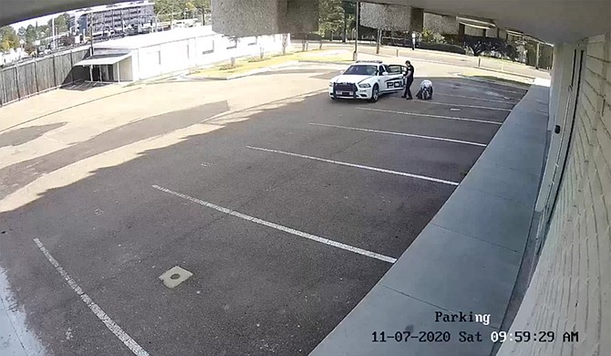 A Ridgeland police officer pictured dropping off a homeless woman at Fondren, Jackson. Screencap courtesy WLBT