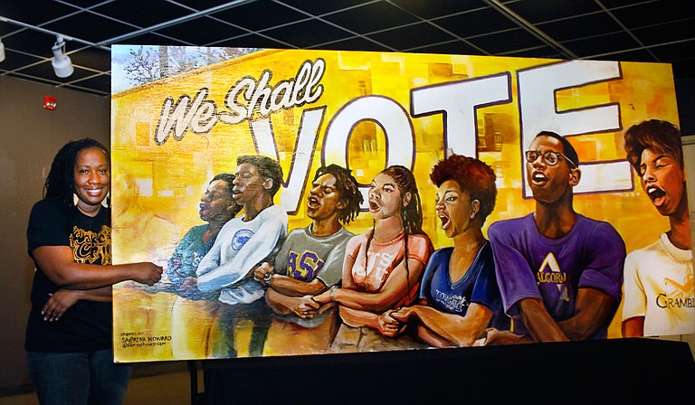 Sabrina Howard poses with her “We Shall…” mural, which is one of six murals included in the local “#ArtofVoting” series. Photo courtesy Sabrina Howard