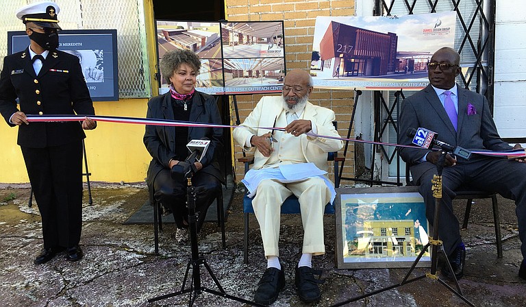 Civil-rights icon James Meredith, flanked by his wife, Judy Alsobrooks Meredith, and an associate, prepares to cut the ribbon for his proposed museum and Bible society headquarters Wednesday. Photo by Kayode Crown