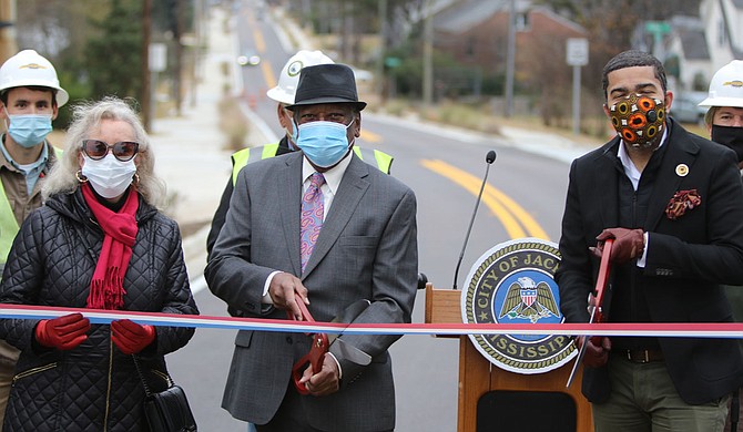 Central District Transportation Commissioner Willie Simmons and Mayor Chokwe A. Lumumba prepare to cut the ribbon to mark the completion of the North State Street project after three years of construction. Ward 7 Councilwoman Virgi Lindsay stands with them. Photo courtesy MDOT