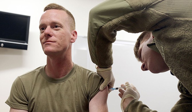 A Jackson National Guardsman receives his vaccination. Guardsmen can help fill roles in vaccine administration, and the State encourages vaccinations for Guard members. Photo by Sgt. Scott Tynes/U.S. Army National Guard