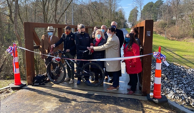 Central District Transportation Commissioner Willie Simmons, Mayor Chokwe A. Lumumba, Dr. Clay Hays, Ward 7 Councilwoman Virgi Lindsay, attorney David Pharr, and others prepare to cut the ribbon Wednesday as the 2.5-mile Museum Trail opens downtown. Photo courtesy Greater Jackson Chamber Partnership