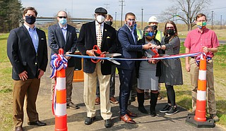 From left: Jackson City Council Vice President and Ward 5 Councilman Charles Tillman, Mayor Chokwe A. Lumumba, Chief of Staff Safiya R. Omari, and Director of Planning and Development Jordan Hillman prepare to cut the ribbon signaling the completion of Lynch Street resurfacing and a multi-use-trail project Wednesday. Photo courtesy MDOT