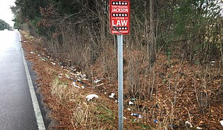 The City of Jackson put a sign on West Highland Drive saying those who throw trash beside the street will a $1,000 fine. But it seems not to be working. Photo by Kayode Crown