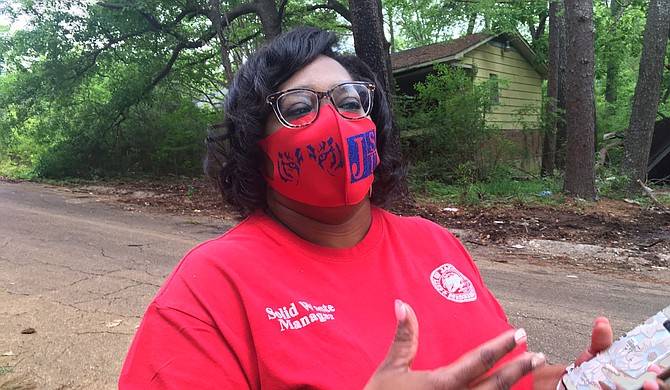 City of Jackson Solid Waste Division Supervisor Lakesha Weathers helps with the clean-up of Glen Erin Street on April 16. Photo by Kayode Crown