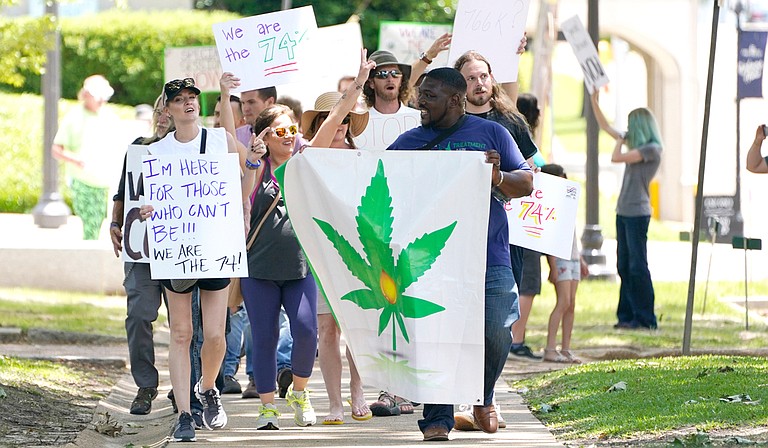 Protesters gathered outside the Mississippi Capitol and Supreme Court to demand that Gov. Tate Reeves call a legislative special session in order to bring back the medical-marijana initiative voters passed last November. Photo by Rogelio V. Solis via AP