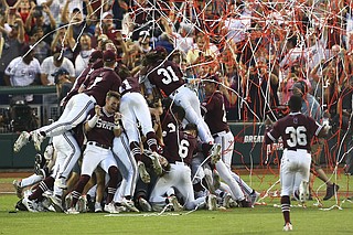 Mississippi State University baseball players jump on the "dawg pile" after their historic win in the College World Series.