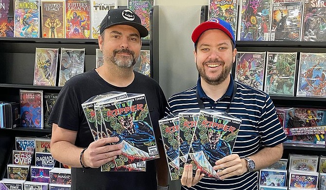 Music and graphic artist Jason Turner (left) poses with Travis Ryder, co-owner of Van’s Comics, Cards and Games in Ridgeland, Miss., which offers issue #0 of “The Ripper Gene,” a comic series based on a mystery novel of the same name. Photo courtesy Jason Turner