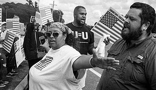 “I really do believe the Supreme Court is going to uphold the Mississippi challenge to (Roe), and what’s going to happen is the South is going to be void of abortion rights. Abortion will be illegal in the South," said Michelle Colon, seen here using her arms to create a barrier between anti-abortion street preacher Keith Dalton and abortion rights protesters in Jackson on Oct. 2, 2021. Photo by Ashton Pittman