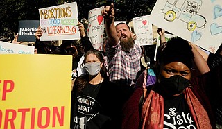 Supporters and opponents of abortion rights rallied, blared music and shouted taunts Wednesday during protests in Mississippi's capital as the state took center stage in a pivotal U.S. Supreme Court case that could end a nationwide right to abortion. Photo by Rogelio V. Solis via AP