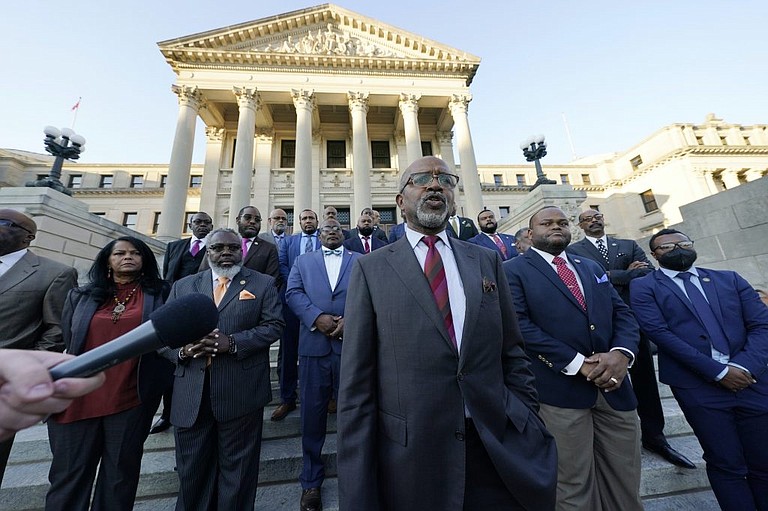 Rep. Robert Johnson, D-Natchez, center, and other members of the House Democratic Caucus express their objections to the body passing Senate Bill 2113, to prohibit the teaching of “critical race theory,” on the steps of the Mississippi Capitol in Jackson, Thursday, March 3, 2022. AP Photo/Rogelio V. Solis