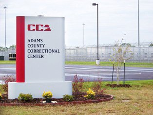 The cause of riot at a private federal prison Adams County is disputed.