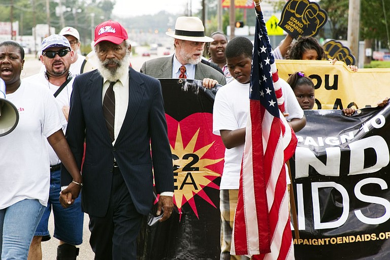 James Meredith holds the hand of Valencia Robinson as she leads the Stand Against AIDS march on Sept 13. The marchers have only 172 miles left to Oxford.