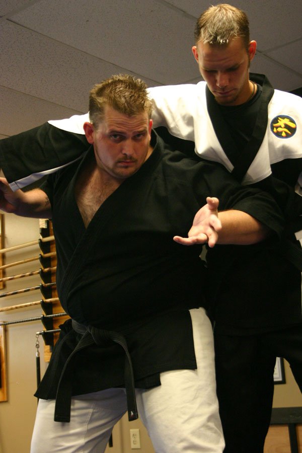 Martial artist Robert Staples (left) demonstrates self-defense techniques in his studio.