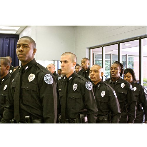 A class of 24 recruits of the Jackson Police Department marches from their seats after taking the oath of office at their graduation on Friday.