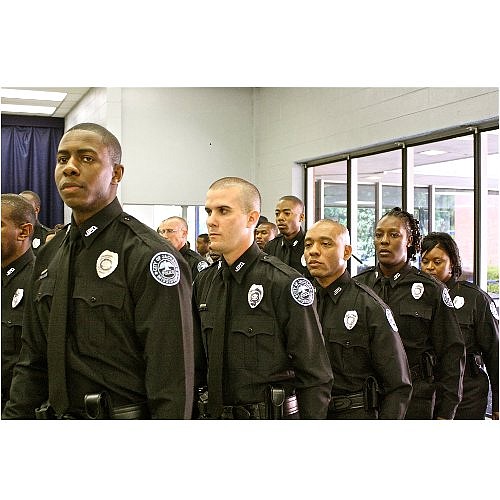 A class of 24 recruits of the Jackson Police Department marches from their seats after taking the oath of office at their graduation on Friday.