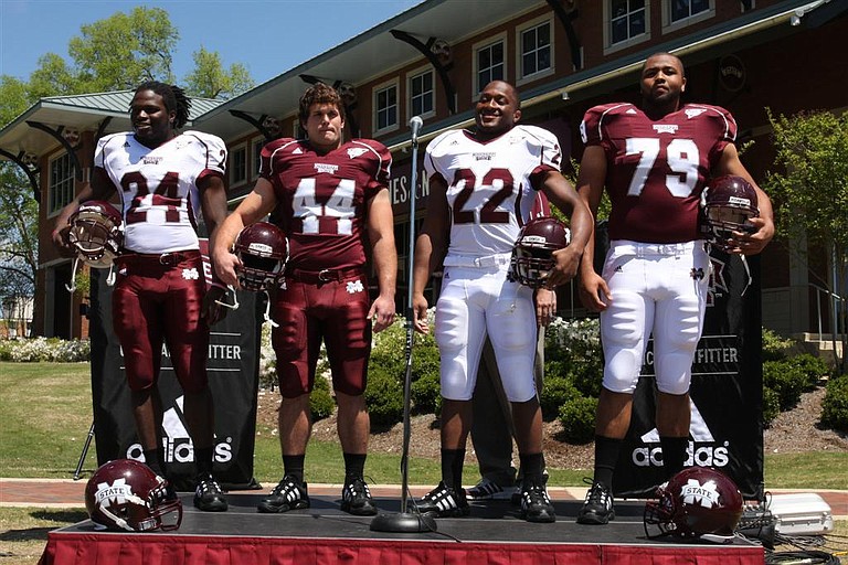 Mississippi State players model the Bulldogs' new uniforms on Wednesday.