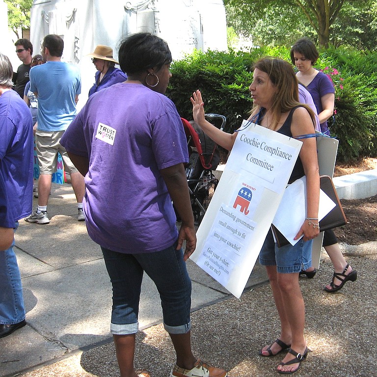 Protesters talk at a rally in Jackson Saturday to protest the "war on women."