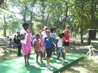 Bernice Wambari (far left), a Jim Hill graduate and Hinds nursing student, leads a dancing session with VOCM intern Ashlea Combs, of Kearney, Neb. (far right), during a July youth rally.