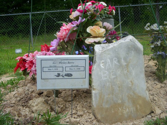 The only "tombstone" at Earl Berry's grave so far is a hand-engraved stone from his brother.